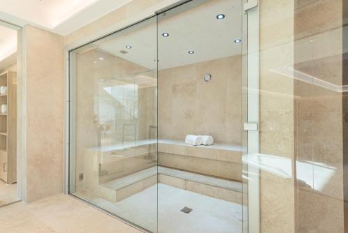 a glass shower stall in a bathroom at Hotel Cala Bona in Cala Bona