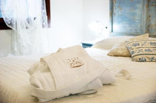 a white towel is sitting on a bed at Stelle Girasoli e Conchiglie in Roncitelli