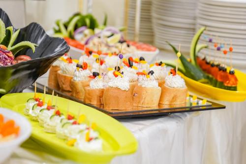 a buffet with cakes and other desserts on a table at Emaar Al Manar in Makkah