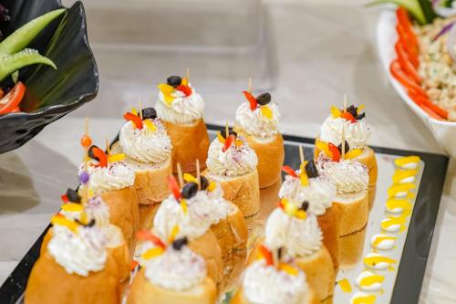 a bunch of sandwiches with whipped cream and fruit on them at Emaar Al Manar in Makkah