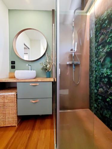 une salle de bain avec un lavabo et un miroir dans l'établissement La Suite du Jardin - Villa 5 etoiles, à Hossegor