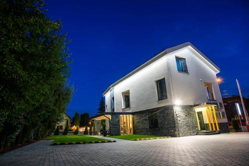 a large white building at night at PENSIUNEA GAMBRINUS **** in Miercurea-Ciuc