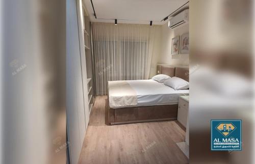 a small bedroom with a bed in a room at للايجار ايام الصيف فيلا فاخره بستيلا هايتس - الساحل الشمالي in El Alamein