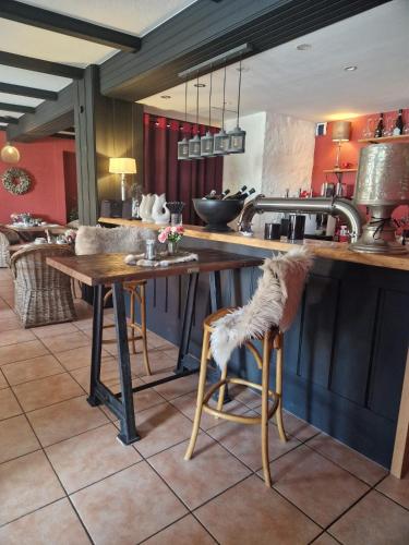a kitchen with a counter with a table and chairs at Hildebrandts Landhotel in Klettbach