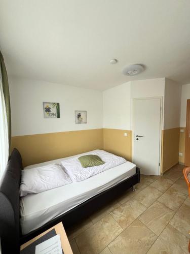a bedroom with a bed in a room at Hotel Restaurant Neffelthal in Kerpen