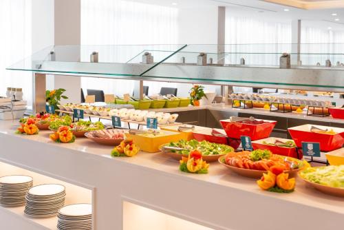 a buffet line with many different types of food at Hotel Cala Bona in Cala Bona