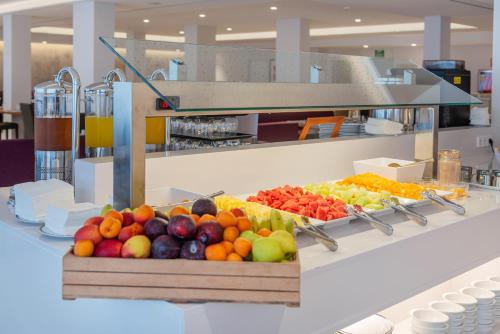 a display of fruits and vegetables on a counter at Hotel Cala Bona in Cala Bona