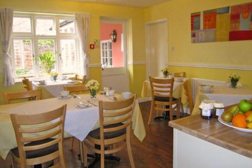 a kitchen and dining room with a table and chairs at The Coach House in Melbourne