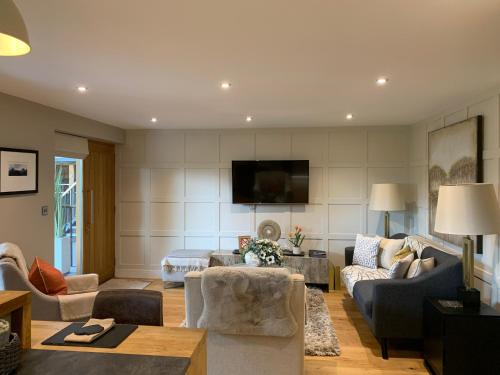 a living room filled with furniture and a flat screen tv at #8 Brunel House Luxury Apartment in Great Malvern in Great Malvern