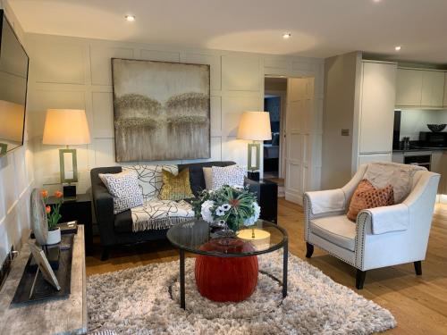 a living room with a couch and a table at #8 Brunel House Luxury Apartment in Great Malvern in Great Malvern