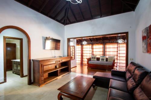 a living room with a couch and a table at Villa Jardín de Buda in Arona