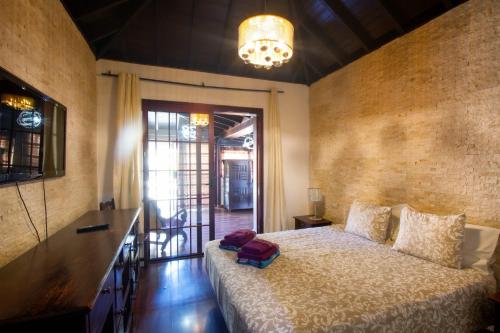 a bedroom with a bed with a bag on it at Villa Jardín de Buda in Arona