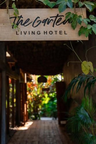 a sign that reads the garden living hotel at The Garten Living in Paje