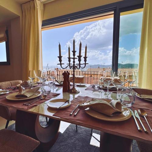 a dining room table with a view of a balcony at VILLTAK SAINT-TROPEZ by VILLTAK Collection in Saint-Tropez