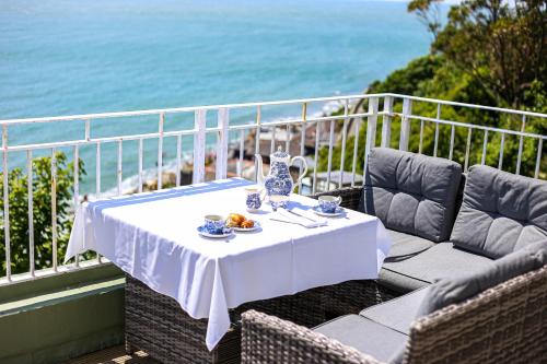 a table with a white table cloth on a balcony at The Wellington Hotel in Ventnor