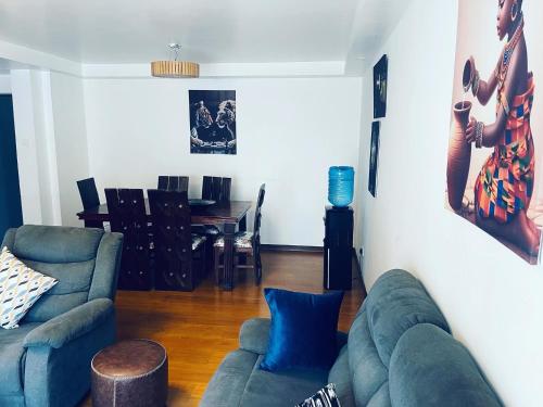 内罗毕Little heaven in ruaka的客厅里有一张沙发和一张桌子。