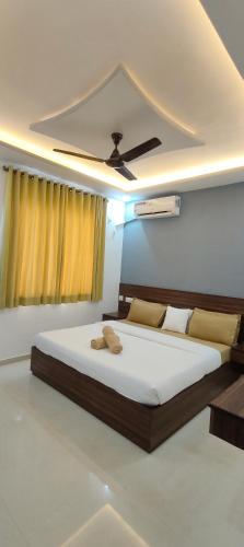 a bedroom with a large bed and a ceiling at Kp's Patnem Beach Apartment in Canacona