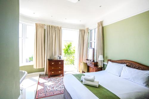 a bedroom with a bed and a window at The Wellington Hotel in Ventnor