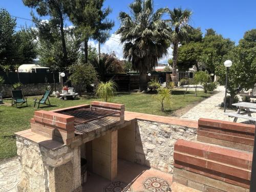 a barbecue grill in a yard with a park at Villa Soleanna Residence in Vieste