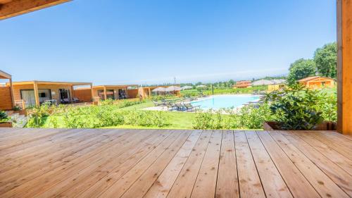 a wooden deck with a view of a pool at Agricamping Ai Prati in Lazise