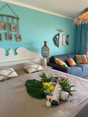 a bedroom with a large bed with flowers on it at Couleur Caraïbes-COCOBEACH MARTINIQUE PIERRE et VACANCES in Sainte-Luce