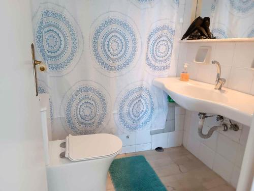 a bathroom with a toilet and a sink at Unbeatable View, Family apartment in Rafina