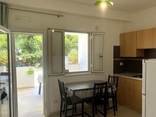 a kitchen and dining room with a table and chairs at Villa Soleanna Residence in Vieste