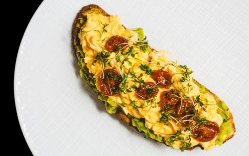 a slice of pizza on a white plate at Boutique Hotel & Restaurant Frenchie in Haarlem