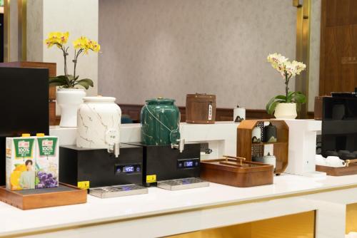 a counter with vases and other items on it at Nostalgia S Hotel Hangzhou West Lake & Hefang Old Street 时光漫步S酒店杭州西湖湖滨河坊街店 Free fresh ground coffee,Free laundry service in Hangzhou