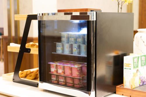 a cooler with food inside of it on a table at Nostalgia S Hotel Hangzhou West Lake & Hefang Old Street 时光漫步S酒店杭州西湖湖滨河坊街店 Free fresh ground coffee,Free laundry service in Hangzhou