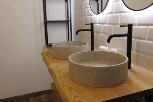 two sinks on a wooden counter in a bathroom at Schättihof in Müllendorf