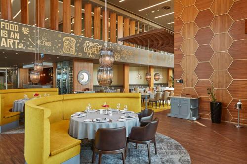 a dining room with a table and chairs in a restaurant at Wyndham Grand Istanbul Levent in Istanbul