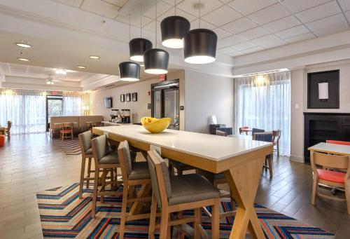 a dining room with a large table and chairs at Hampton Inn Buffalo-South/I-90 in West Seneca