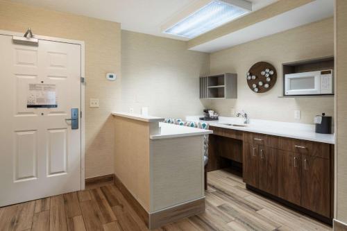 a large kitchen with a sink and a white door at Hampton Inn Buffalo-South/I-90 in West Seneca