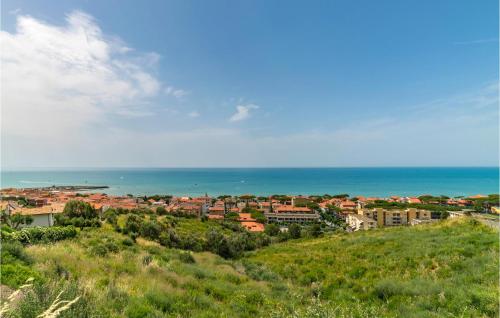 a town on a hill with the ocean in the background at Apt B5 in Grosseto