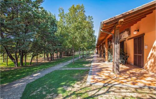 an empty path next to a building with trees at Apt B5 in Grosseto