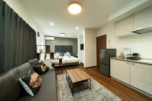 a kitchen and a living room with a couch and a bed at 88, Kanegafuchi 3A, Entire house for rent, 鐘ヶ淵3A in Tokyo