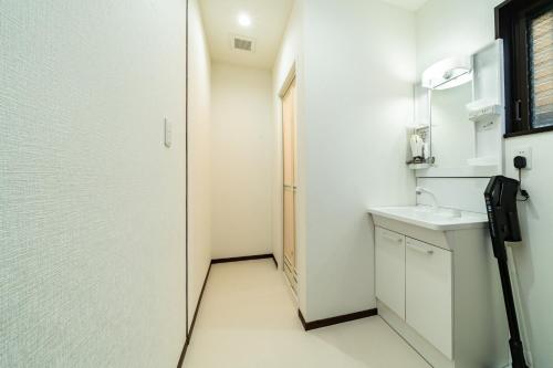 a small bathroom with a sink and a mirror at 88, Kanegafuchi 3A, Entire house for rent, 鐘ヶ淵3A in Tokyo