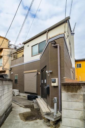 a brick house with a door on the side of it at 88, Kanegafuchi 3A, Entire house for rent, 鐘ヶ淵3A in Tokyo