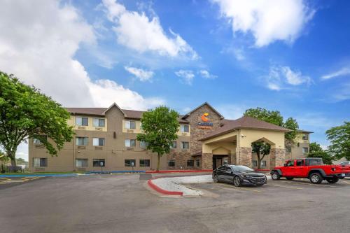 a hotel with a car parked in a parking lot at Comfort Suites Omaha East-Council Bluffs in Council Bluffs