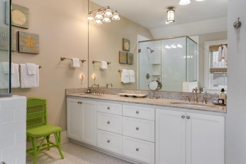 a bathroom with a sink and a large mirror at Red Cedar - 25 Sea Oats Lane in East End