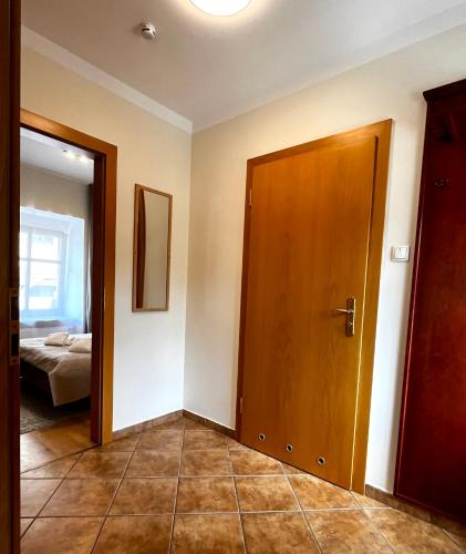 an empty room with a door and a bedroom at Apartamenty Nyskie in Zgorzelec