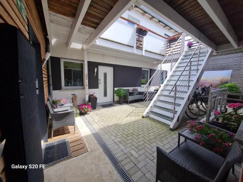 a patio with a spiral staircase in a house at Mara in Lübeck