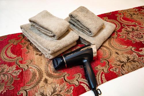 a blow dryer and two towels on a table at 88, Kanegafuchi 3A, Entire house for rent, 鐘ヶ淵3A in Tokyo