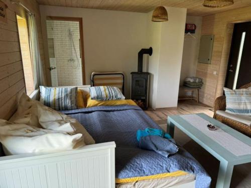 a living room with a bed and a stove at Orion majutus in Pärnu