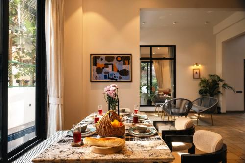 a living room with a table with food on it at Casa De Roopa by Stay ALYF, Mandrem in Mandrem