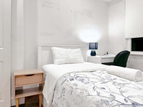 a bedroom with a bed and a desk with a chair at Ultimo Homestay in Sydney
