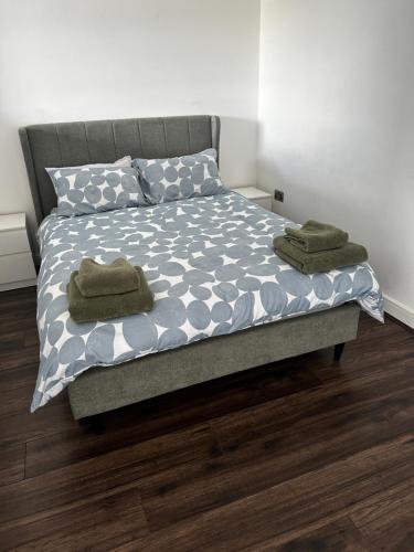 a bed with two towels on it in a bedroom at 533 Luxury Double Studio Apartment Sleeps Two in Birmingham