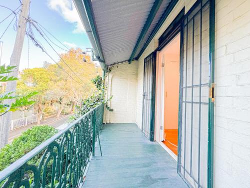 a balcony of a building with an open door at Ultimo Homestay in Sydney