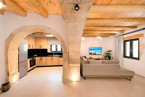 a living room with a couch and a kitchen at Roustico Luxury Villa Heated Whirpool in Rethymno Town